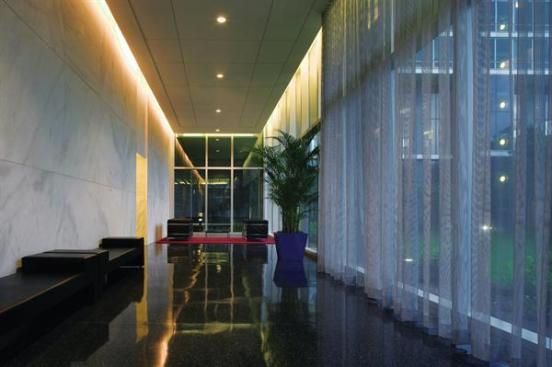 Each of the three towers has its own ground-floor elevator lobby. Terrazzo floors add grandeur while reducing maintenance, and cove lighting hidden above a floating panel adds loft to an already generously high ceiling.