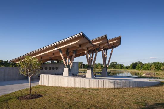 Glue-laminated superstructures rest on wood columns on the south side, while a board-formed concrete bearing wall offers privacy.