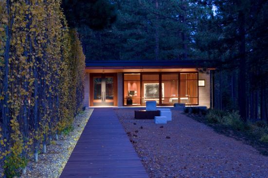 Restrictive zoning on the lake edge limited building area coverage. Basins buried under the gravel sculpture garden help keep all the storm water on site.