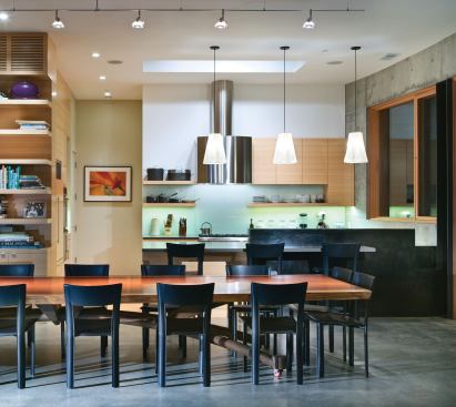 Clean geometry and an abbreviated finish schedule yield interiors that are relaxingly simple. The dining area centers on a table whose top is a single slab of reclaimed redwood.