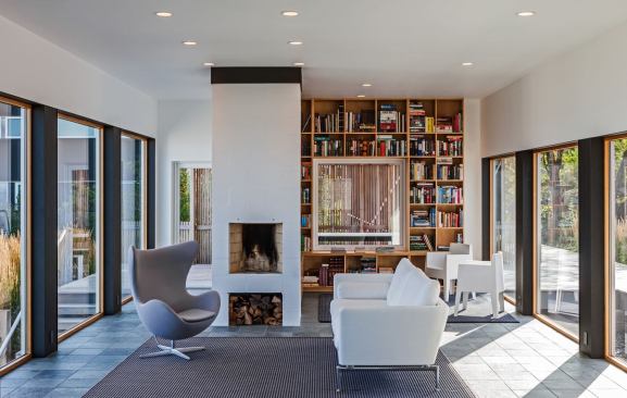 The interiors of the Hall House use glass and white paint to create layers of sightlines, views, and natural light.