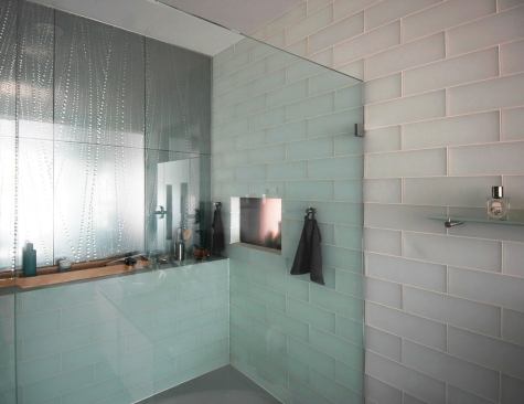 The wife's bathroom is much lighter with more delicate finishes compared with the husband's.