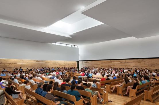 The new Quaker Meeting Room was once the gym. The  space is articulated with a series of floating architectural planes that  modulate natural and electric light.