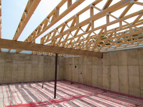 During construction, workers installed tubes in the basement slab for in-floor radiant heating.