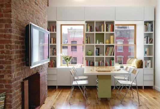 A desk/fold-away bed, fold-down dining table, and under-floor storage compartments help maximize space.