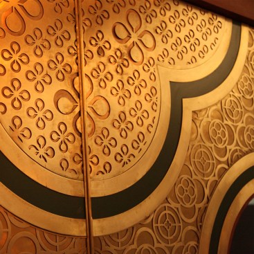 The detail of the main door showing the intricate art work and the use of metals copper and brass in layers