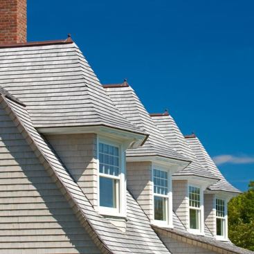 Architect: Jacob Albert, Albert, Righter & Tittmann, Boston, MA &nbsp; Large Marvin windows and French doors on the seaside elevation make the most of the ocean view. Dramatic repetition of pointed dormers pairs Marvin double hung windows on an angle to better capture the sweeping views to the water.