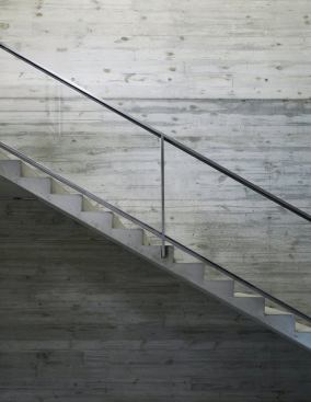 Board-formed concrete lines the interior stairwell.