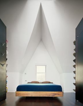 Removing a dropped ceiling revealed the underside of the steeply pitched roofline, and near its peak, a skylight. The left storage bank holds a colorful sneaker collection.