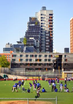 View of south façade showing solar array and connection to community.