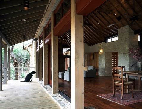 Jennett Country House, Wimberley, Texas – accordion doors connect those porches to the living and dining rooms for indoor-outdoor living