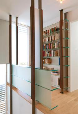 The shelving system doubles as a guard rail at the second floor.