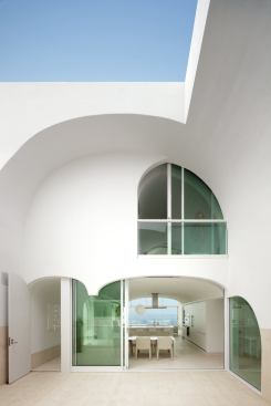 In addition to providing light and outdoor living space, the courtyard divides the home into a family volume, seen here with the master suite stacked over the kitchen, and guest volume, seen in the photo opposite.