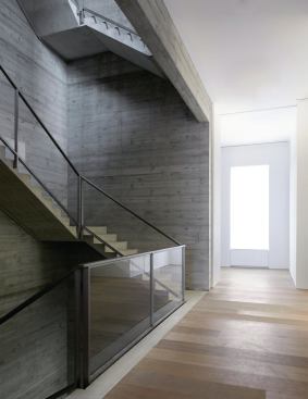 Light from above atrium stair filters into the open floors below.