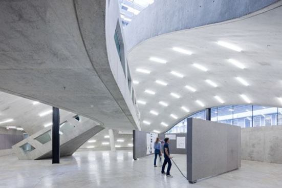 A custom frosted acrylic lamp sleeve was designed to alleviate concerns about glare from the T5HO lamps. The lighting control system allows light levels to be adjusted for special events and automatically dims the lights when the space is not in use.