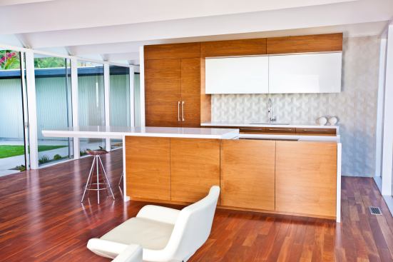 Bradco Kitchens and Baths’ sliding kitchen island countertop is remote-controlled and motorized to reveal a cooktop and downdraft while extending counter space. Bradco, www.bradcokitchen.com; 323.936.3457.