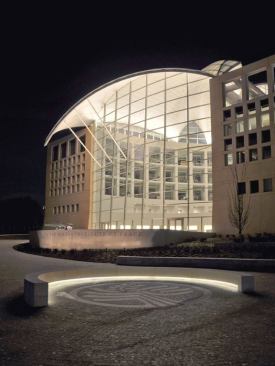 The building relies on its interior lighting to  achieve its façade lighting. Site lighting elements are kept at a minimum; a  few bollards, an LED striplight in the curving bench, and a wash on the  inscription wall.