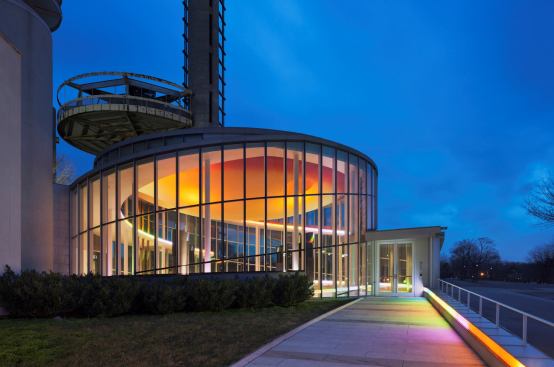 Cold-cathode tubes lead visitors to the building entrances and then continue inside, following the curve of the building's spiraling form.