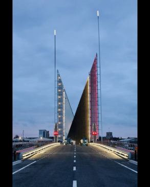 As the bridge opens, it transforms into a sail-like structure. The middle segment — ­the asphalt roadway and metal-grate pedestrian walkway — ­pivots open and is cut on the bias. As the leaves rise up to full vertical, the two segments stand in opposition and it appears as if two sailboats are passing.