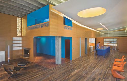 L Residence  Award of Excellence 
Min|Day This Omaha, Neb., penthouse apartment makes visual use of physical “pockets” of space to hide service areas. Because the space had 15-foot ceilings but small, low windows, Min|Day conceived of a design that pushed the utilitarian spaces together into a two-story pocket, forming an open L-shaped interior that allows the living space to function as a “pseudo exterior” partially framed by a smooth, wood-veneer wall.