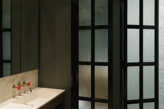 The bathroom doors are made of salvaged wire-frame windows