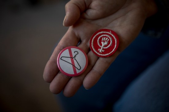 Retired Atlanta-based social worker Sharon Wood holding a pro-choice pin and patch which she last wore in 1973.