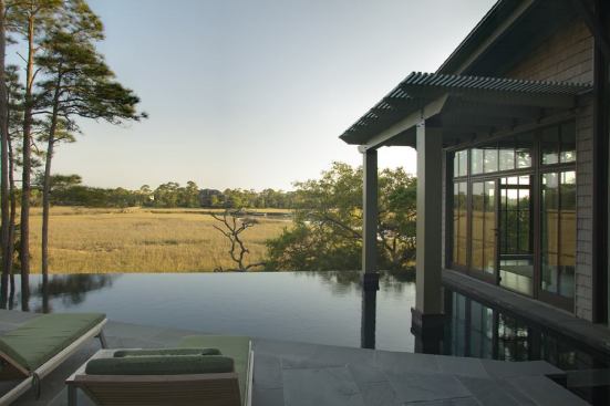 The disappearing-edge pool links the master bedroom to the home’s main public spaces. It faces south, toward a tranquil marsh.
