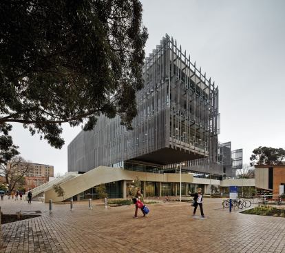 The steel-and-concrete-framed building is designed to showcase a variety of architectural systems to the students inside, who are learning the craft of architecture. Thus the structure of such elements as this cantilevered stack of workspaces on the northeastern edge of the building is left exposed. The metals fins and louvers shade the glass-enclosed volume of the building.