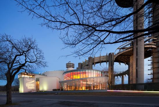 Theater illuminated at dusk.
