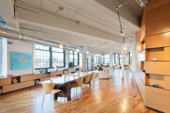 The design team retained whatever valuable materials it could, restoring the wood floors and cleaning the 11-foot-tall load-bearing brick walls.