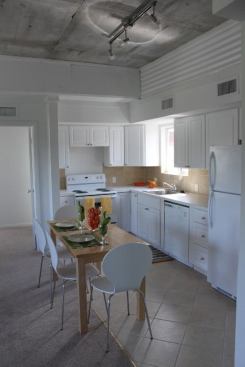 The unit features straightforward finishes and exposed concrete ceilings.