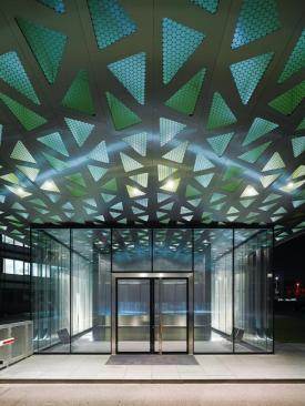 With the new gatehouse, the architects and their client realized a longstanding shared ambition: to use Trumpf's own technology to construct a building entirely of laser-cut and welded sheet metal. Above the gatehouse's functional core, which is enclosed in a glass pavilion, a honeycombed stainless steel roof cantilevers more than 60 feet.