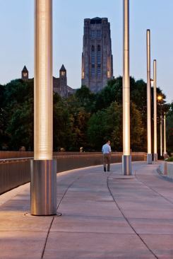 The illuminated handrails use 3000K linear LED fixtures to provide a wash of light along the sidewalk. Drivers are concealed in the niche at the retaining wall below.