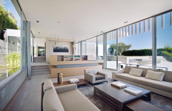 The home's open plan uses a subtle level change to delineate between the dining room and living room.