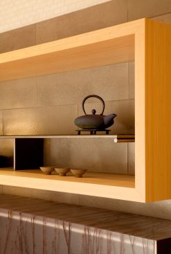 Open shelving that extends from the kitchen to the dining area houses favorite tea sets.