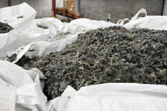 The shredded reclaimed carpet backing will be loaded into an agglometer machine and melted into pellets to make Interface’s reclaimed PVC backing. The white bags that transport the shredded backing will also be reused.