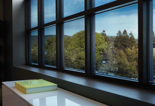 Guardian Industries and View (formerly Soladigm) have introduced 
SunGuard EC, a dynamic architectural glass product that helps control heat and glare inside a building using electrochromic technology. The glazing transitions from clear to tinted in response to either manual or automated controls. In its fully tinted state, the glass has a visible transmittance (VT) of 0.03 and a solar heat gain coefficient (SHGC) of 0.09. In its clear state, the glass has a VT of 0.58 and an SHGC of 0.46. The tint level can be adjusted to one of four settings. 
guardian.com