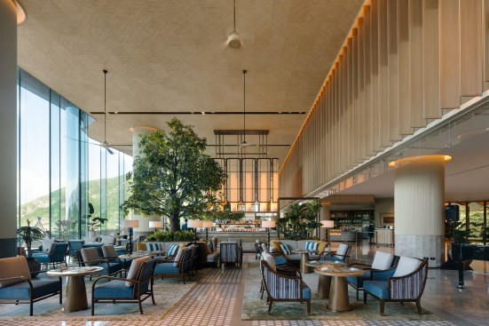 Double-height glass brings ample sunlight to the lobby lounge