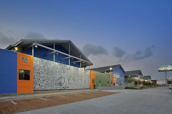 The stenciled-metal wall is meant to buffer freeway noise, but it also adds texture and vibrant color to this housing project, which helps individuals transition out of homelessness. 
Project: New Hope at Brays Crossing, Houston; 
Architect: Glassman Shoemake Maldonado Architects, Houston; 
Builder: Camden Builders, Inc., Houston
