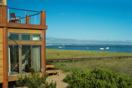 The bedroom windows at the home’s west end have cross-braces of stainless steel rods, which let light in while offering hurricane protection. They’re also a nod to the area’s industrial past.