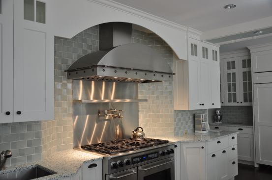 Brushed stainless steel hood with custom blackened-steel rivets and pot-rail. Project: Private Residence, Greenwich, Conn.; Designer/Fabricator: Brooks Custom, Mt. Kisco, N.Y.