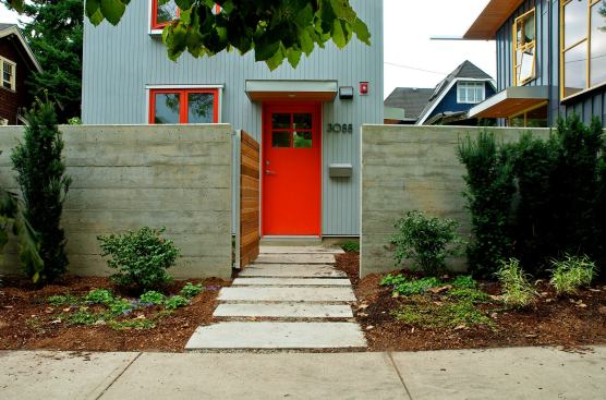 A small patio in the front yard is accessed directly off a series of stone slabs that lead to the front door.