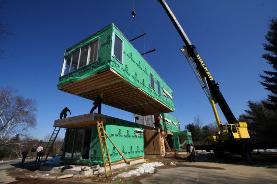 Prefab modules being set by crane.