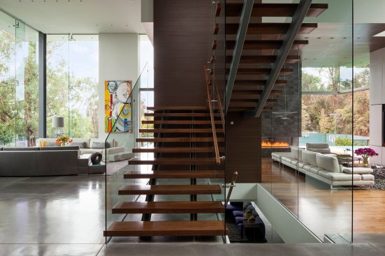 Beverly Hills modern home open central volume with floating stairs and double height glass walls.