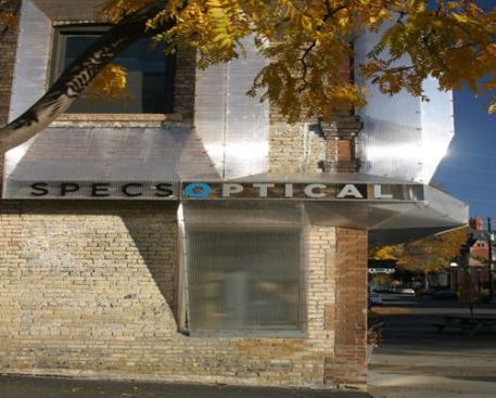 SPECS Optical Facade  Award of Excellence 
Alchemy Architects Shrubbery shrouded this 100-year-old building’s façade and local signage regulations kept its owners, SPECS Optical in Minneapolis, from installing a sign that could be seen from behind the bushes. Alchemy Architects in neighboring St. Paul, Minn., devised a high-tech solution that keeps the existing structure’s facade intact while alerting passers-by to the goings on inside: a 5/8-inch-thick rigid crystalline envelope made out of triple-layered greenhouse polycarbonate, shaped into protruding, self-supported triangles. Read 
ARCHITECT magazine’s project coverage 
here.