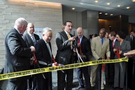 Washington, D.C. Mayor Vincent C. Gray and other district officials cut the ribbon—or in this case, the ceremonial yellow crime scene tape—to open the new headquarters of the Department of Forensic Sciences.