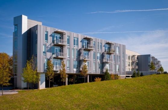 This design very nicely humanizes the scale of a very large project, both in plan with the use of the smaller pods with individual entrances and community rooms, and in elevation through the articulation of windows and balconies. These moves provoke a more personal connection with the building and encourage community building, which may in turn foster a more socially sustainable place.