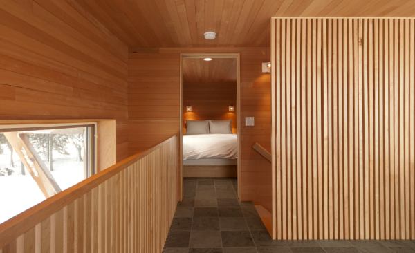 Salmela often employs wood screens to let light into a space while providing visual separation—as at the Rierson Cabin in Tofte, Minn.