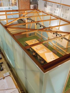 The studio's central volume is framed in 2x4s and clad in salvaged 10-foot-by-5-foot sheets of sandblasted glass.