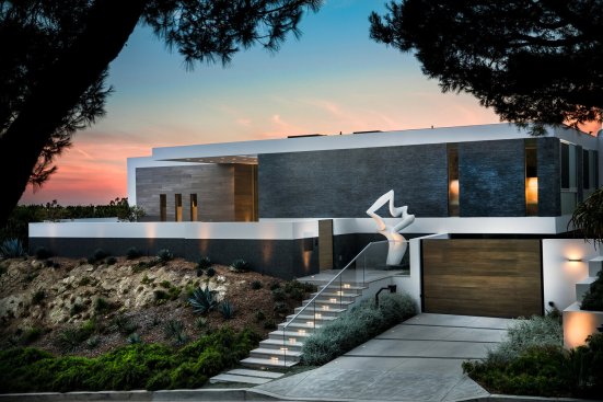 Driveway, custom art and front entry of modern Beverly Hills home.